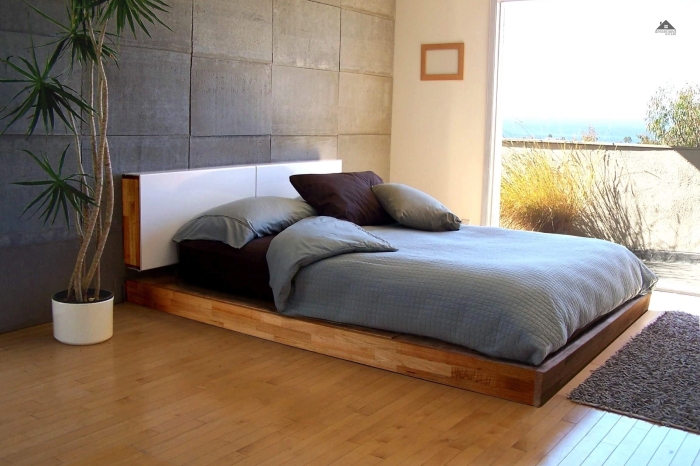 Floating Bed With Stone Accent Walls And Sliding Doors